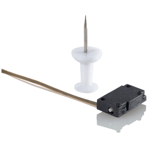 Nanomotion Edge motor next to a pin for scale, showing extreme miniaturization