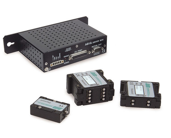 AB1A driver box alongside piezoelectric motor elements of varying sizes